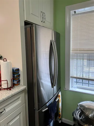 a view of a refrigerator and window in a kitchen