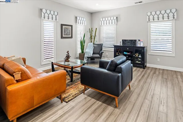 a living room with furniture and wooden floor
