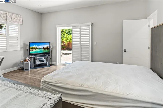 a bedroom with a bed and a flat screen tv