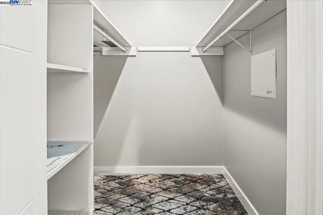 a view of walk in closet with empty racks