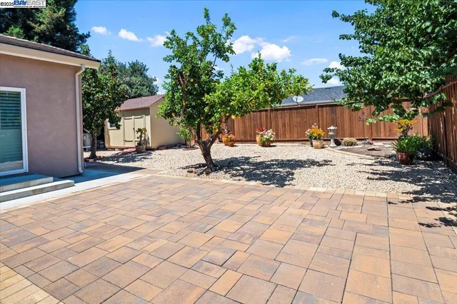 a front view of a house with a yard and garden