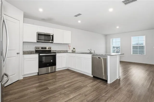 a kitchen with a stove top oven sink and cabinets