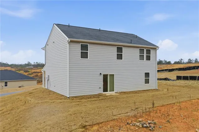 a view of a house with a backyard