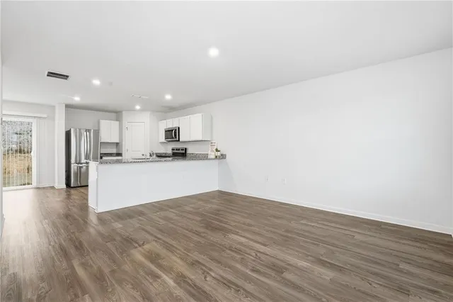 a view of kitchen dining table and wooden floor