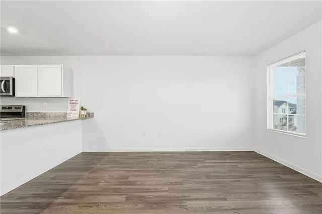 a view of kitchen with wooden floor and window