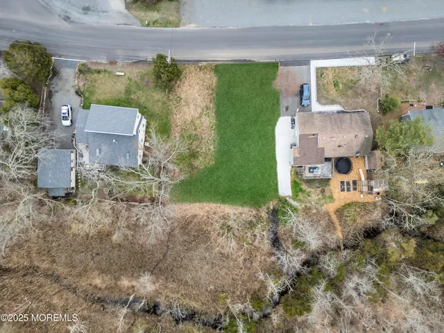 an aerial view of a house with garden space and street view