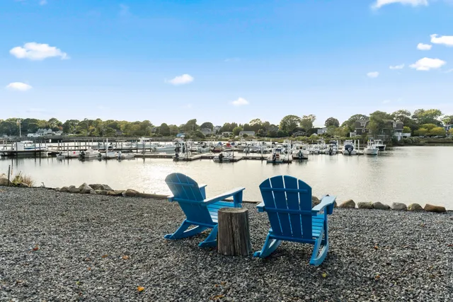 a view of a lake with table and chairs