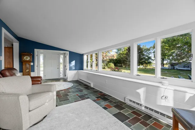 a living room with furniture and large windows