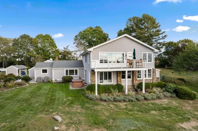 a front view of a house with a yard and trees