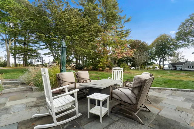 a view of a chairs and table in backyard of the house