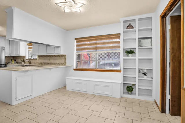 a kitchen with cabinets and a stove top oven