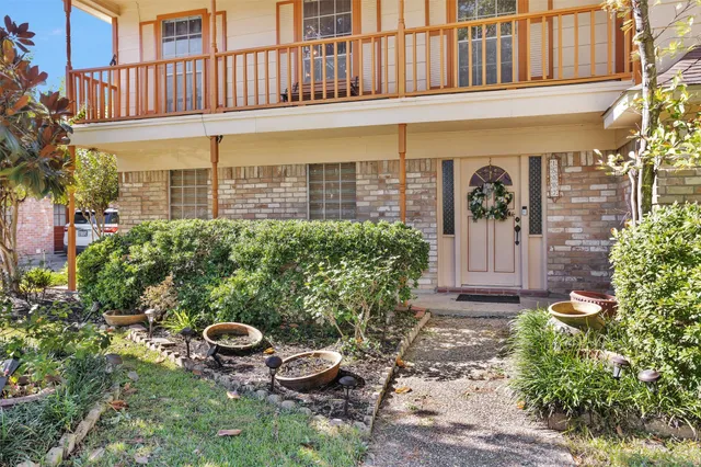 a view of a backyard with plants and outdoor seating