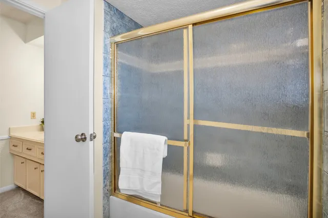 a bathroom with a glass shower door