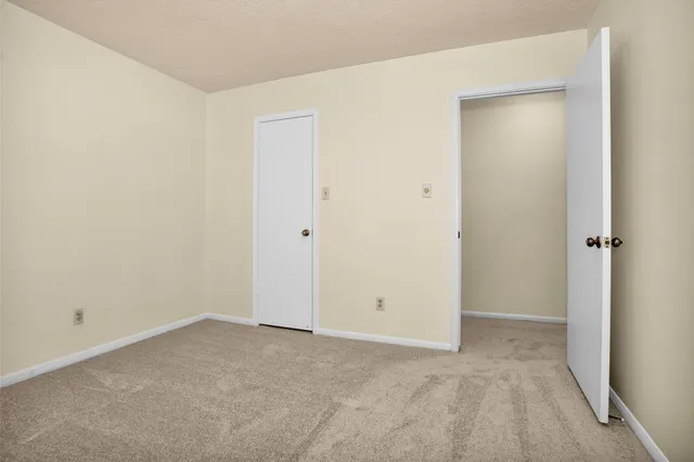 a view of a patio with a table and chairs
