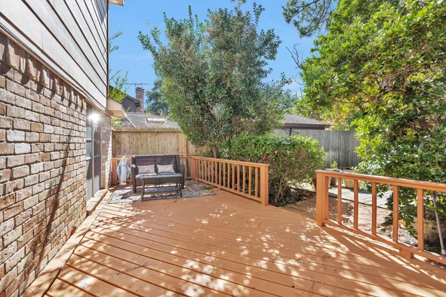 a balcony with wooden floor and outdoor seating