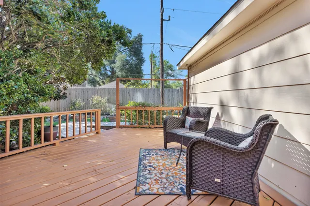 a view of a patio with couches table and chairs and wooden floor