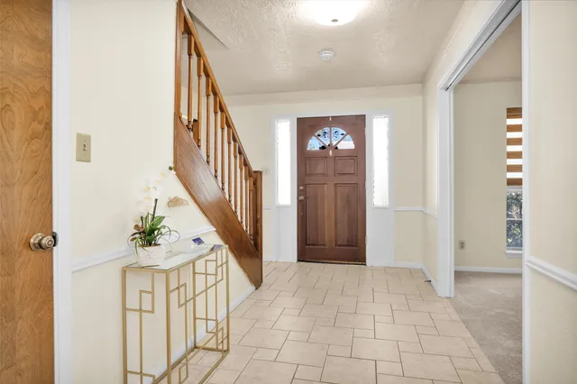 a view of an entryway with wooden floor