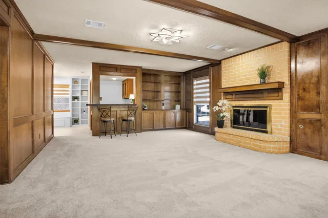 an empty room with furniture and a fireplace