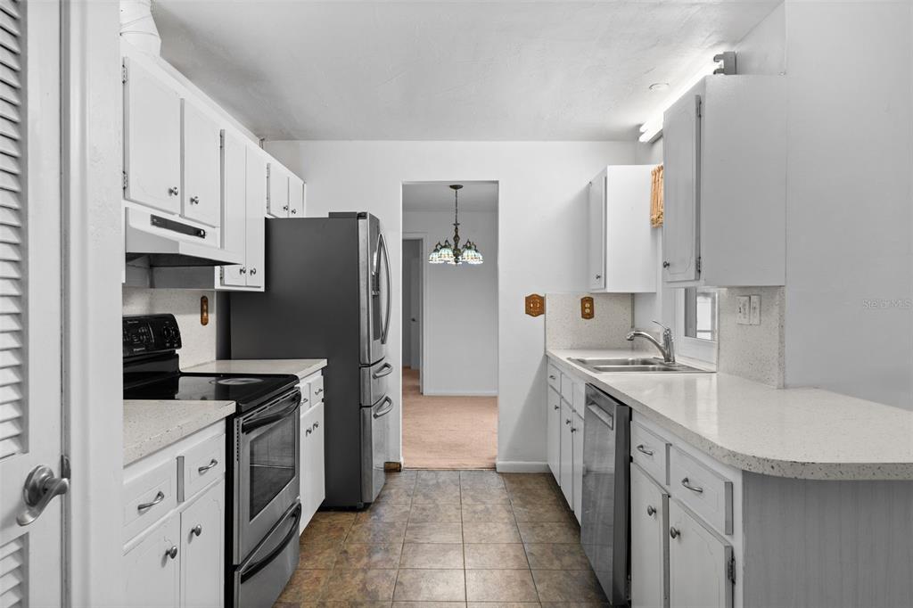 1540 Northwest 10th Street Boca Raton, FL 33486 - Photo 14 of 38 a kitchen with granite countertop a refrigerator stove and sink