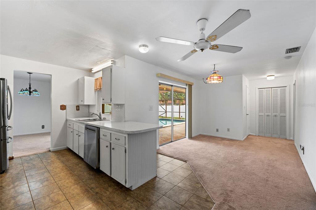 1540 Northwest 10th Street Boca Raton, FL 33486 - Photo 16 of 38 a view of a kitchen with a sink and dishwasher a refrigerator with wooden floor