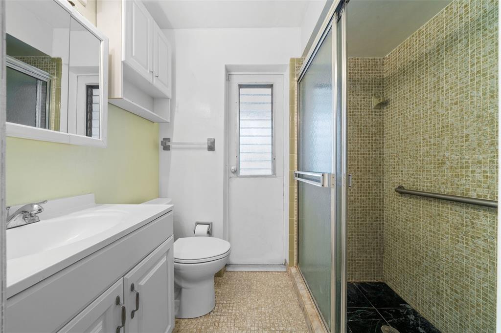 1540 Northwest 10th Street Boca Raton, FL 33486 - Photo 27 of 38 a bathroom with a sink toilet and shower