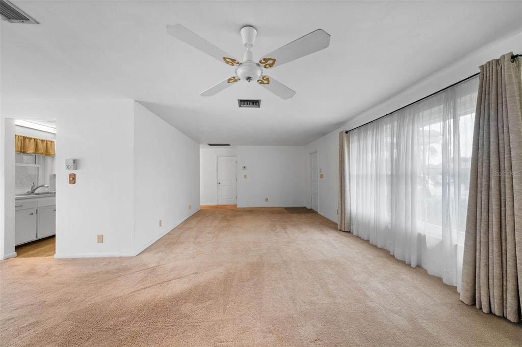 1540 Northwest 10th Street Boca Raton, FL 33486 - Photo 8 of 38 an empty room with chandelier fan and windows