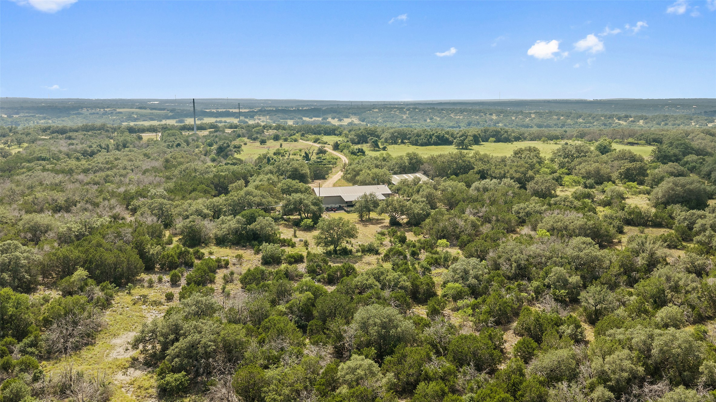764 Stubbs Road Johnson City, TX 78636 - Photo 5 of 29 Discover a tranquil country escape, boasting a private residence amidst a sprawling, verdant landscape.