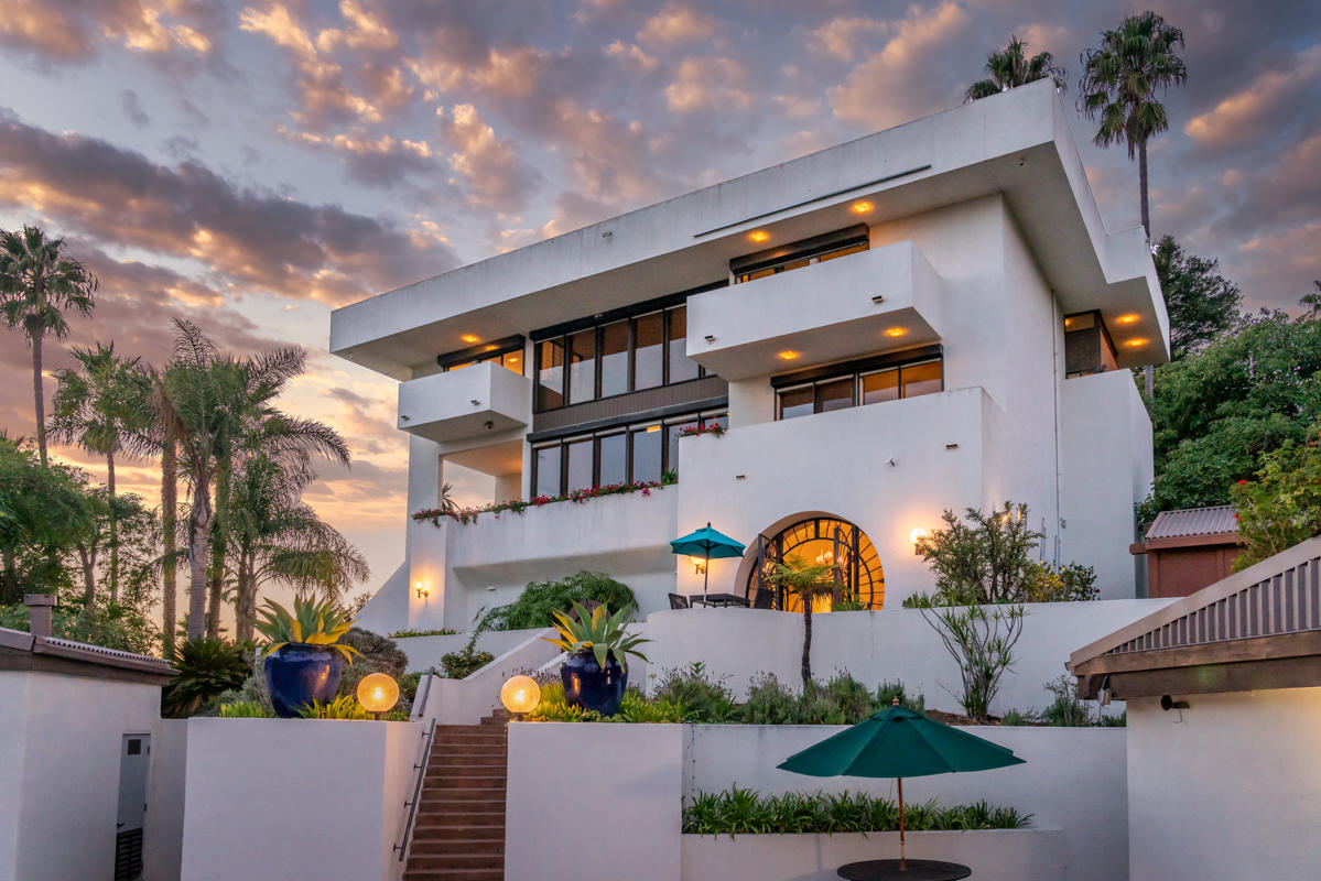 350 Las Alturas Road Santa Barbara, CA 93103 - Photo 1 of 49 a front view of a house with a yard and a large tree