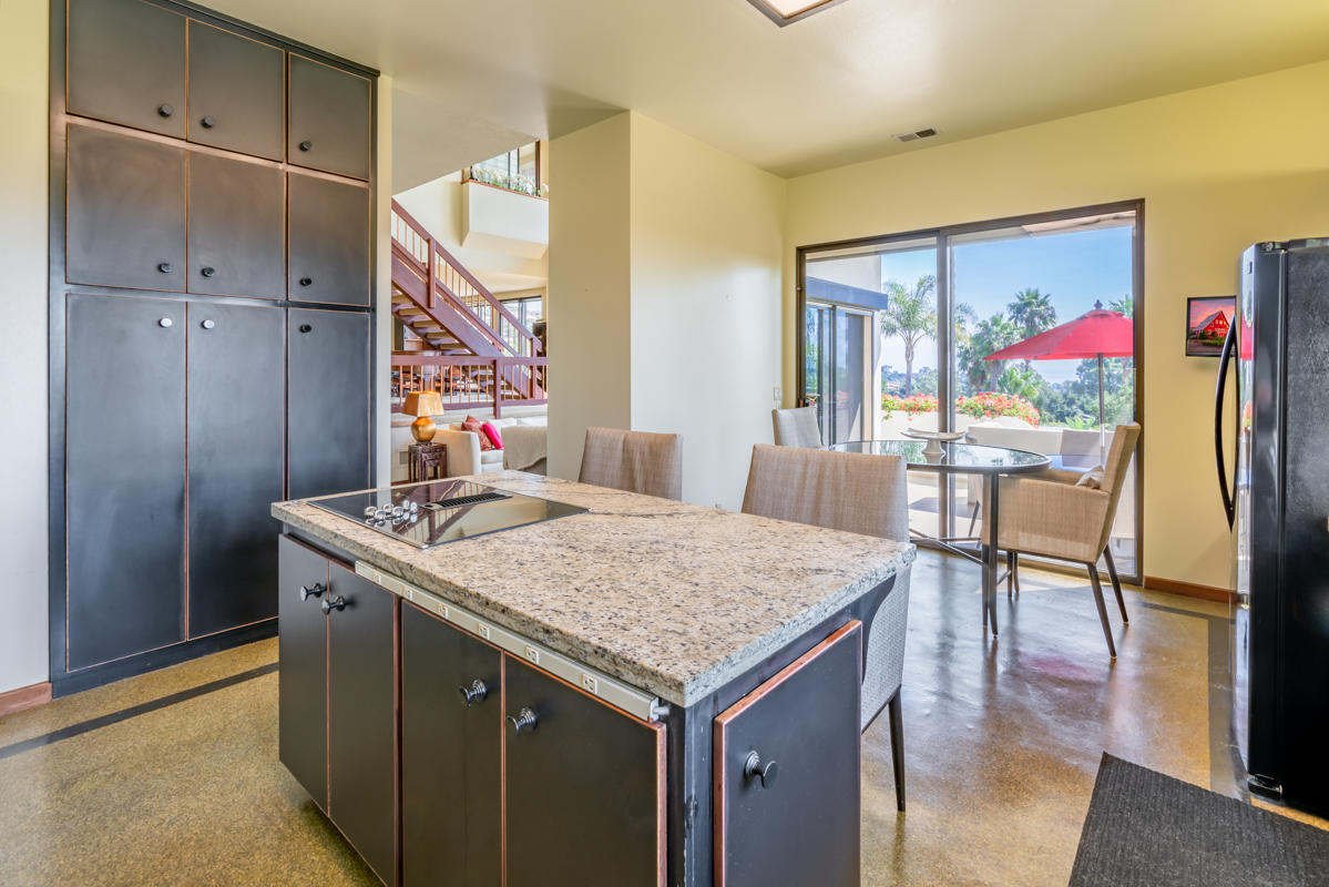 350 Las Alturas Road Santa Barbara, CA 93103 - Photo 21 of 49 a kitchen that has a kitchen island wooden cabinets and stainless steel appliances