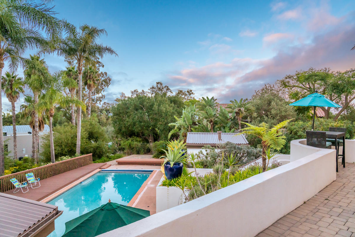 350 Las Alturas Road Santa Barbara, CA 93103 - Photo 31 of 49 a view of a swimming pool with an outdoor seating and a garden
