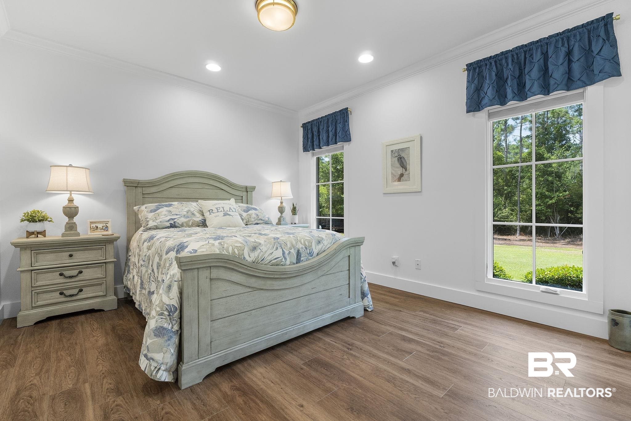 4451 Millhouse Road Gulf Shores, AL 36542 - Photo 34 of 50 Bedroom featuring multiple windows and hardwood / wood-style flooring