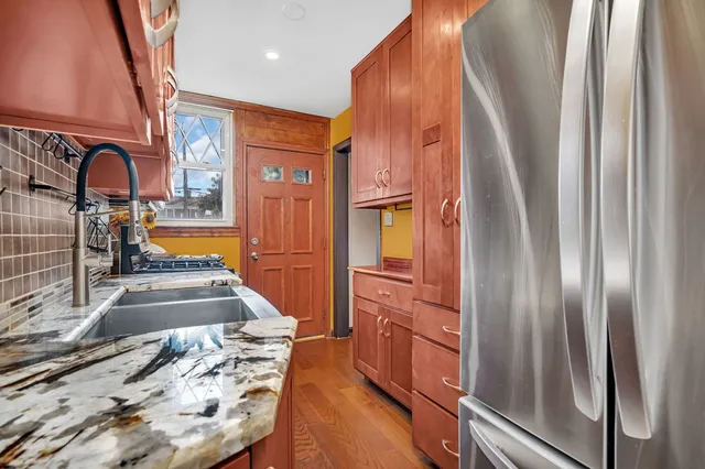 a view of a kitchen with a sink and wooden floor
