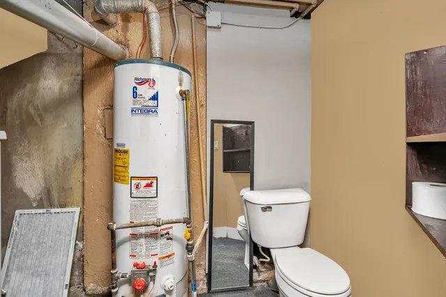 a white toilet sitting next to a bathroom sink