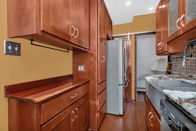 a kitchen with stainless steel appliances granite countertop a sink stove and refrigerator