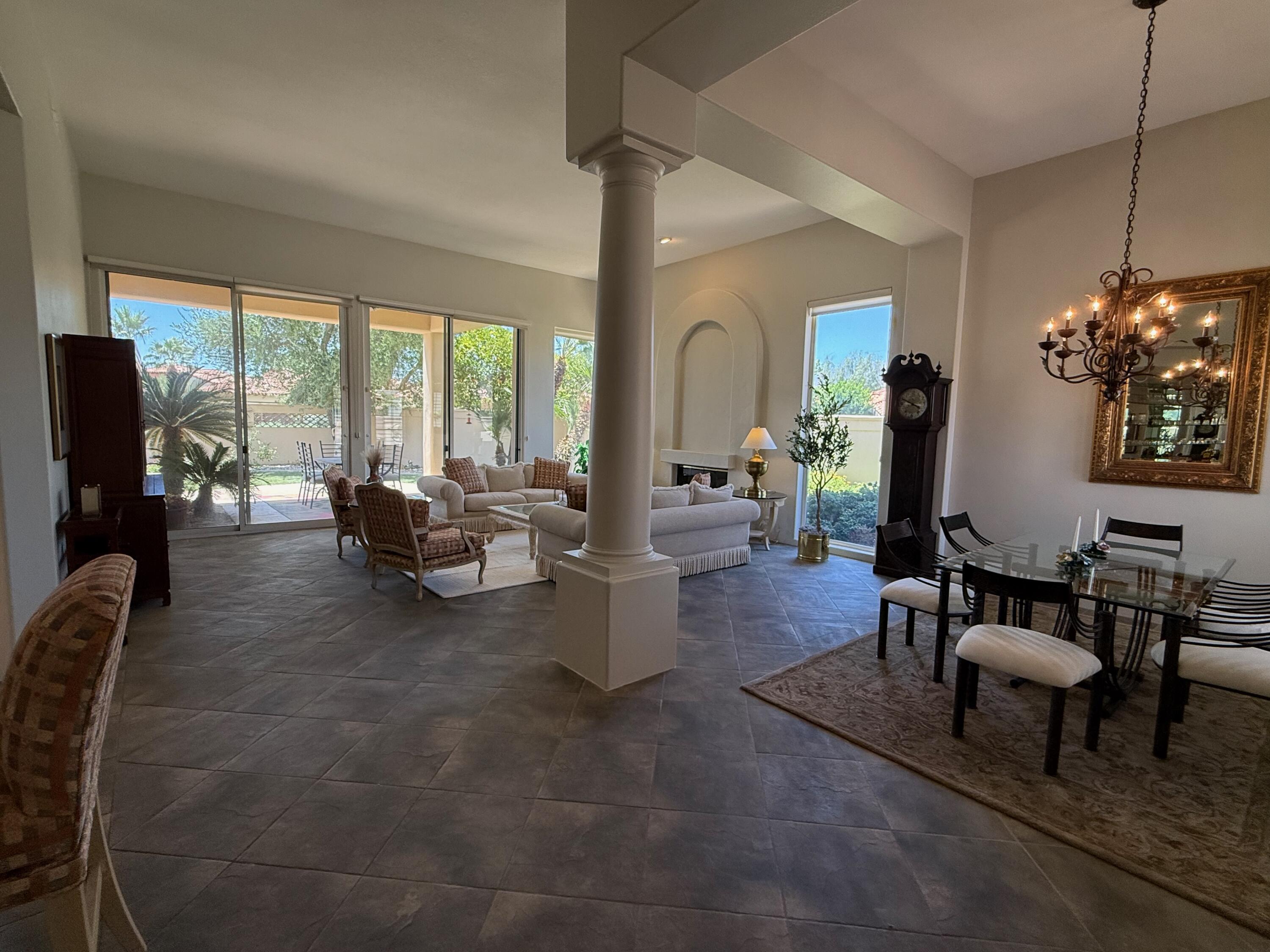 79765 Tangelo La Quinta, CA 92253 - Photo 12 of 55 a living room with fireplace furniture and a large window