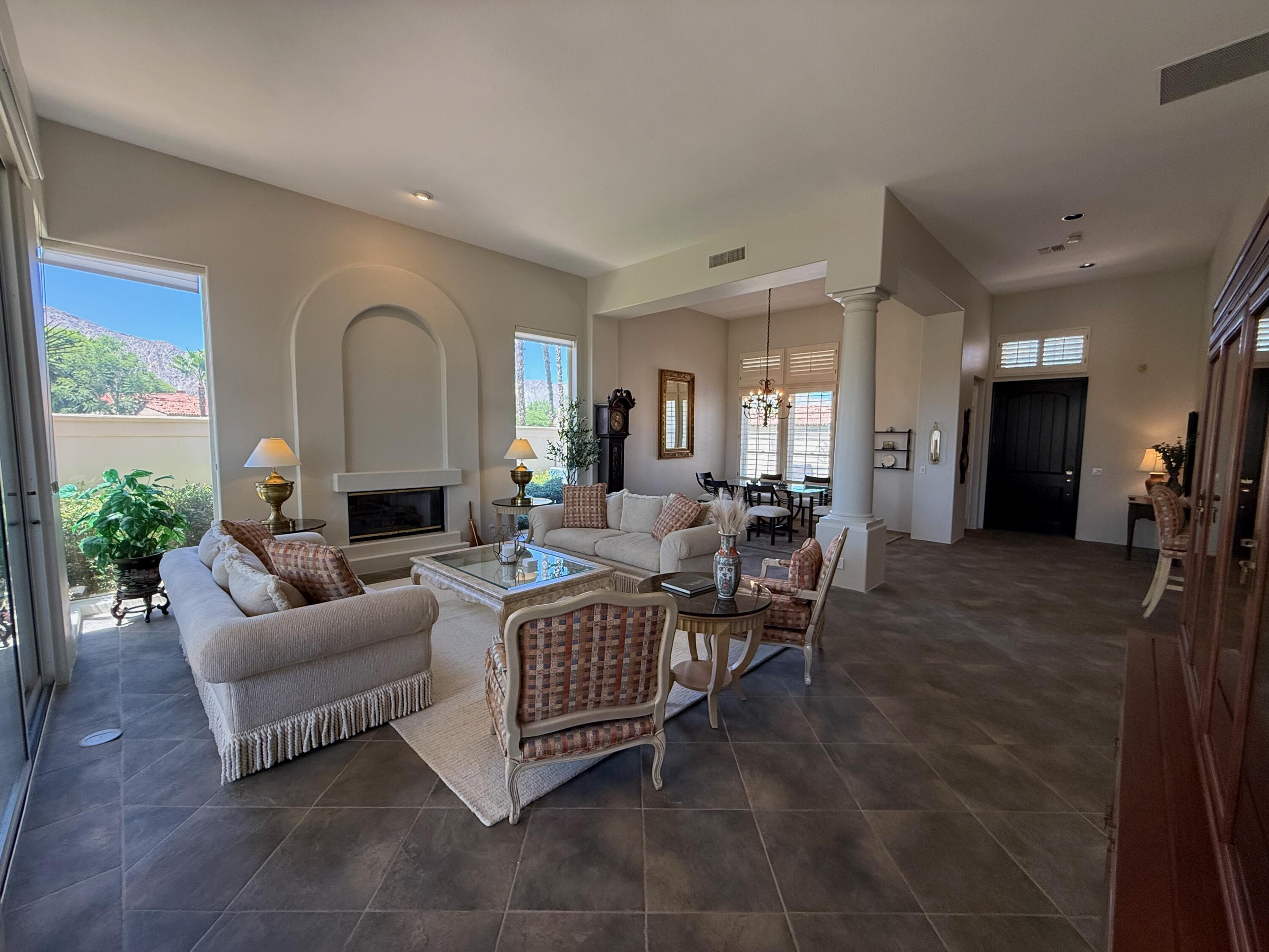 79765 Tangelo La Quinta, CA 92253 - Photo 17 of 55 a living room with furniture wooden floor and a large window