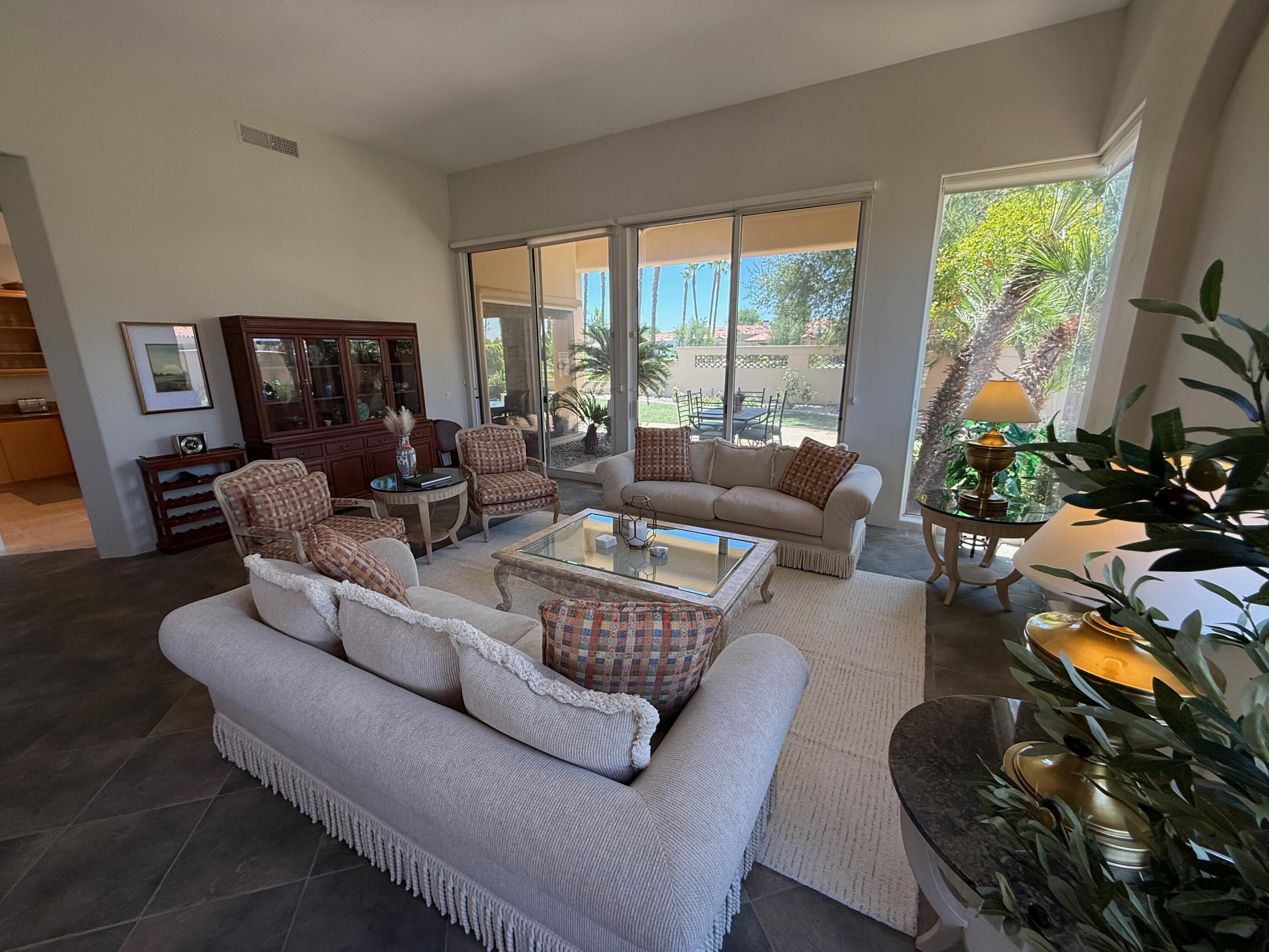 79765 Tangelo La Quinta, CA 92253 - Photo 18 of 55 a living room with furniture fireplace and a large window