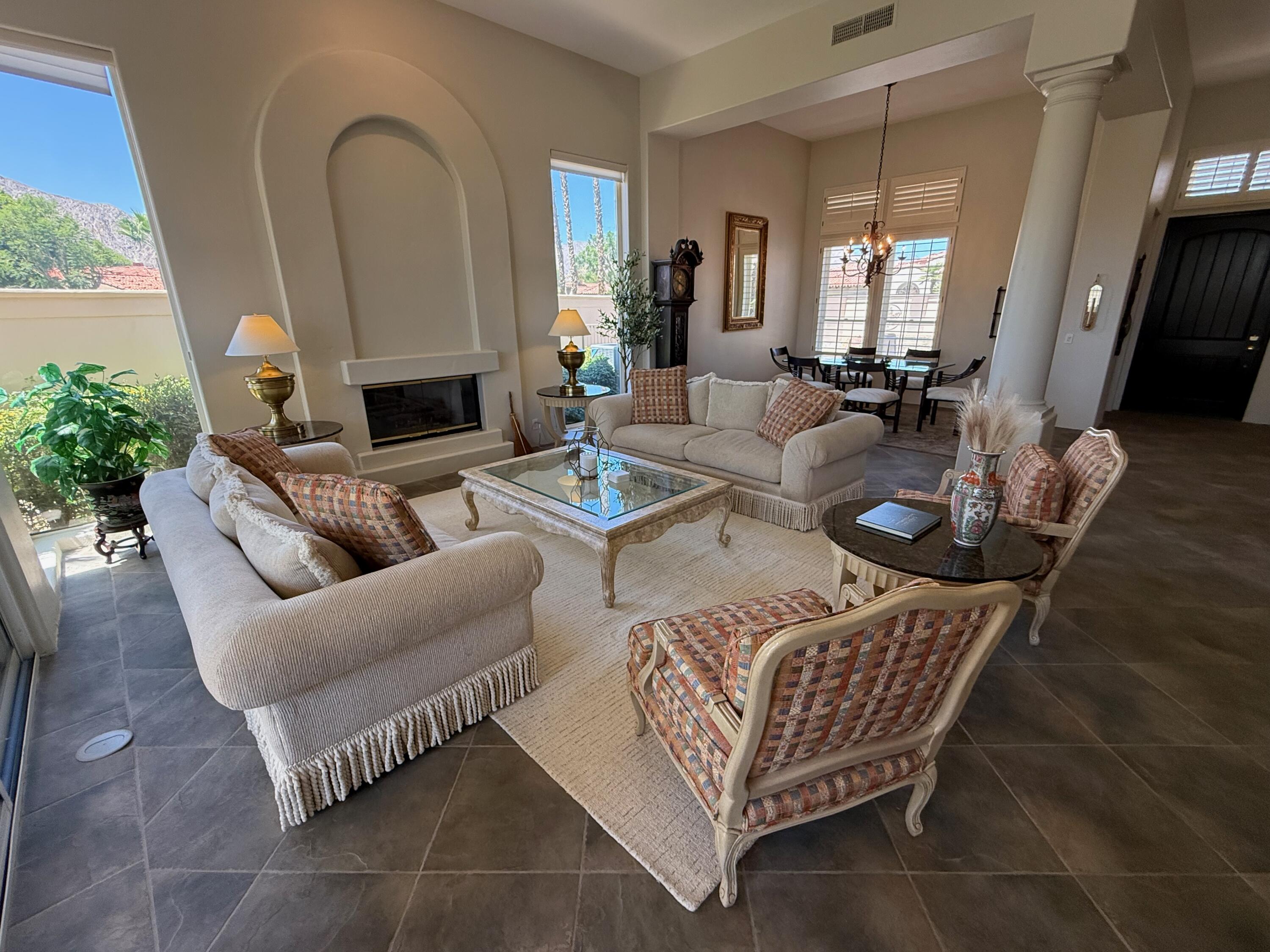 79765 Tangelo La Quinta, CA 92253 - Photo 20 of 55 a living room with furniture fireplace and a potted plant