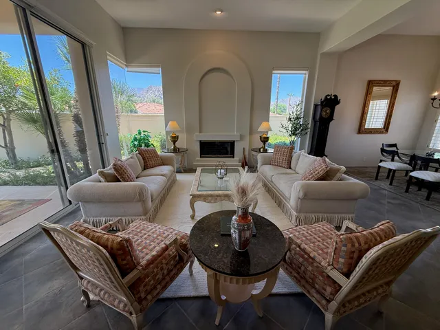a view of a house with a big yard and large trees