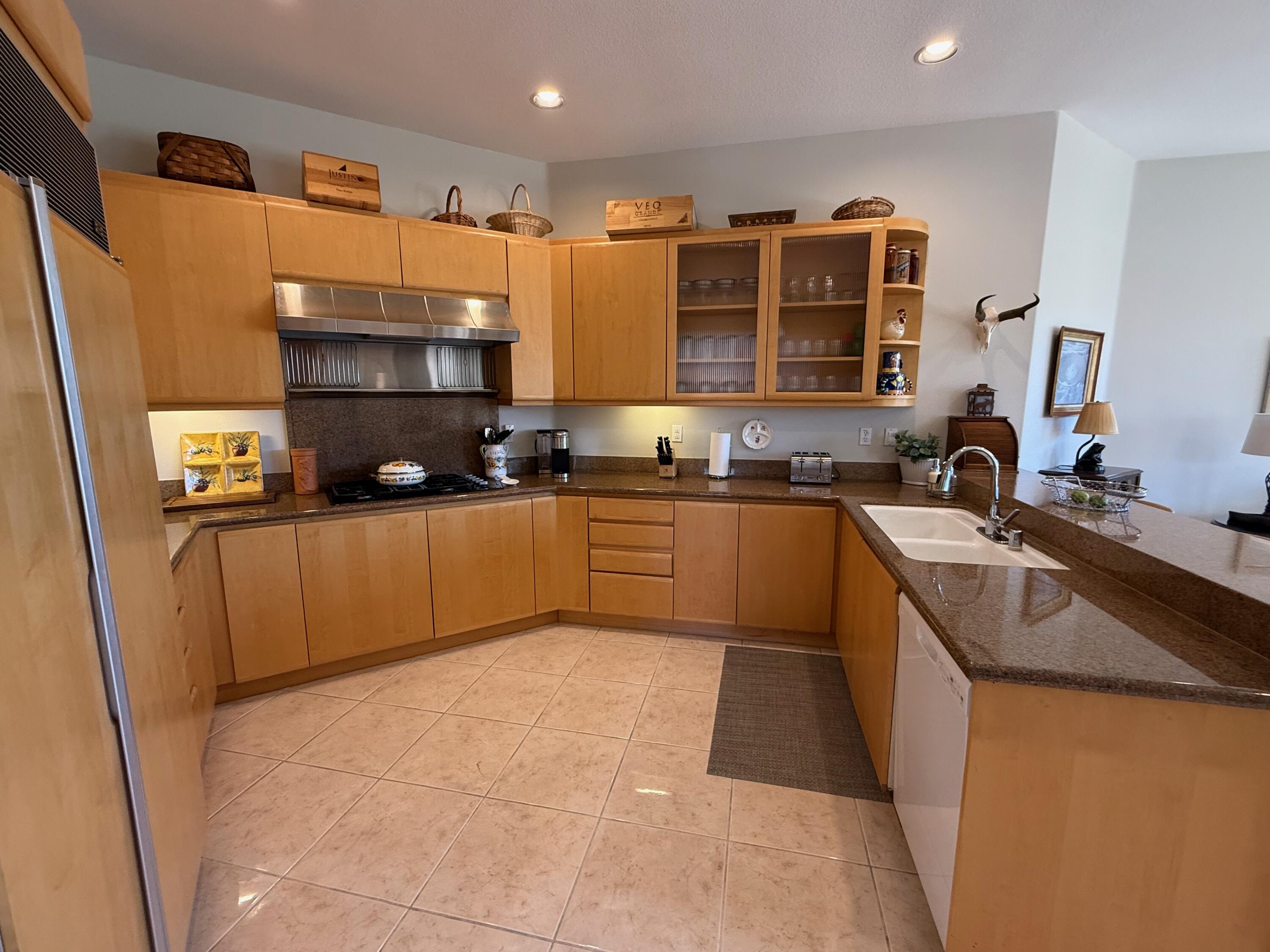 79765 Tangelo La Quinta, CA 92253 - Photo 24 of 55 a kitchen with a sink a stove and cabinets