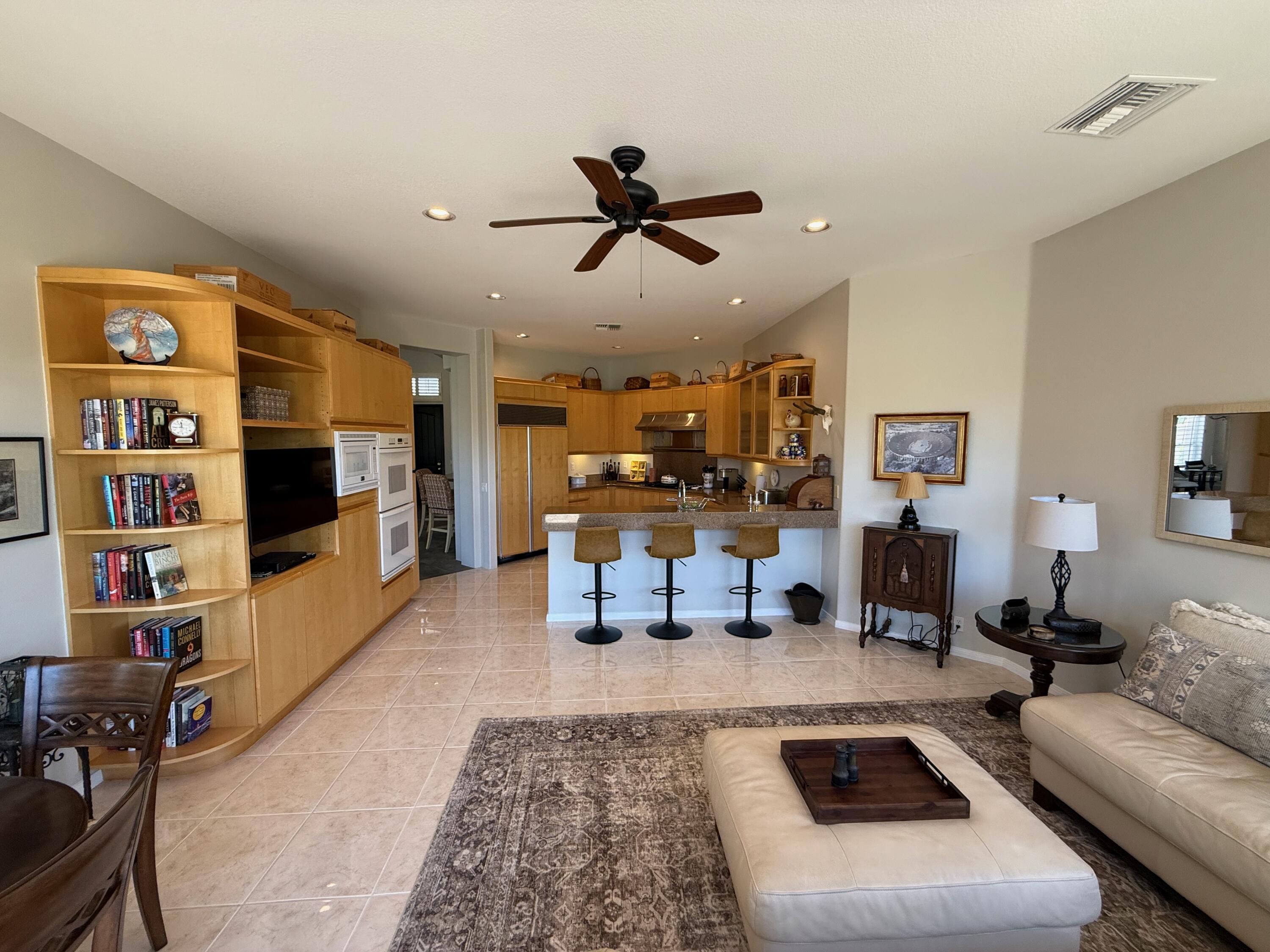 79765 Tangelo La Quinta, CA 92253 - Photo 26 of 55 a living room with furniture or couch and a book shelf