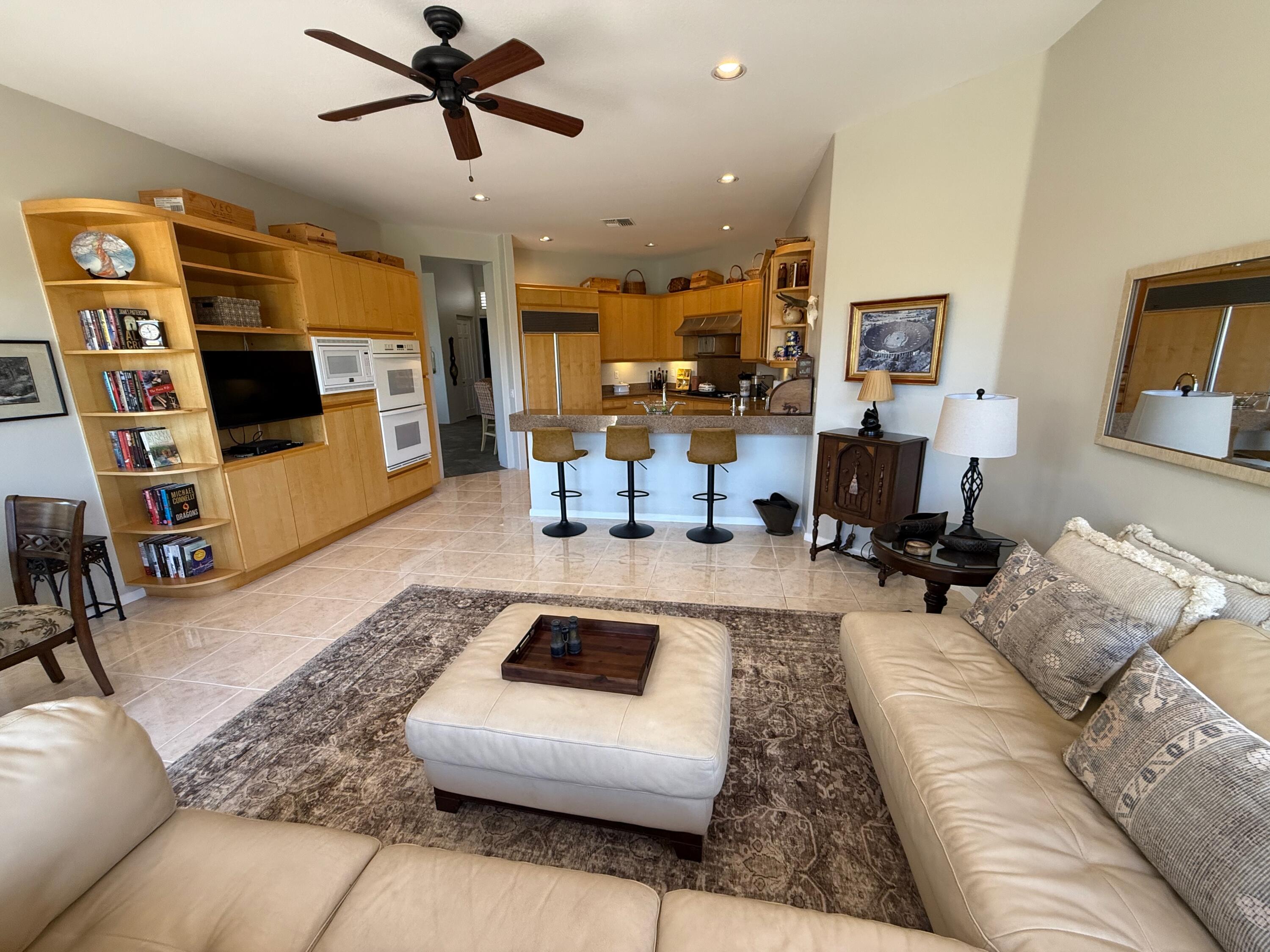 79765 Tangelo La Quinta, CA 92253 - Photo 27 of 55 a living room with furniture and a flat screen tv
