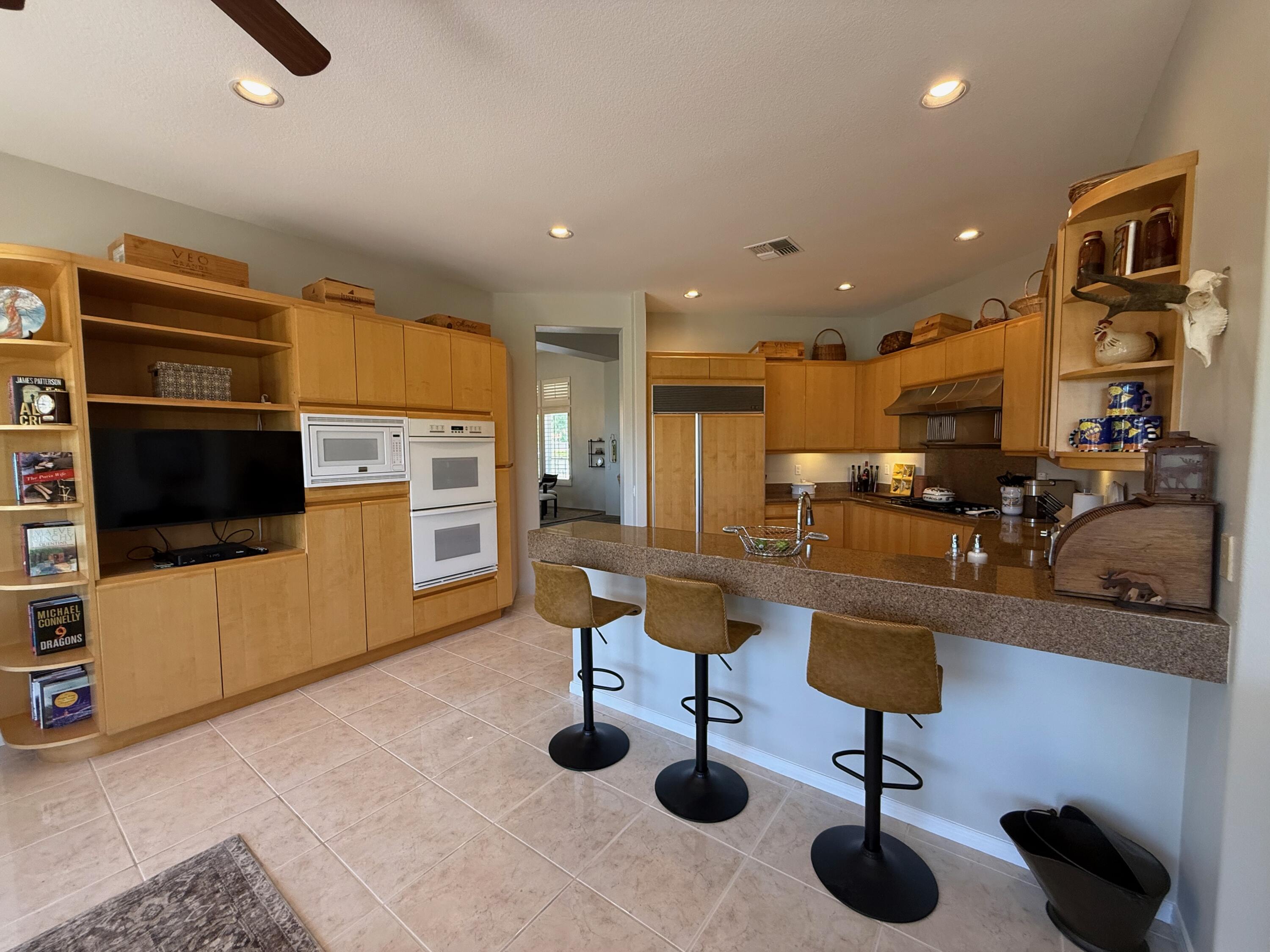 79765 Tangelo La Quinta, CA 92253 - Photo 28 of 55 a living room with furniture and a flat screen tv