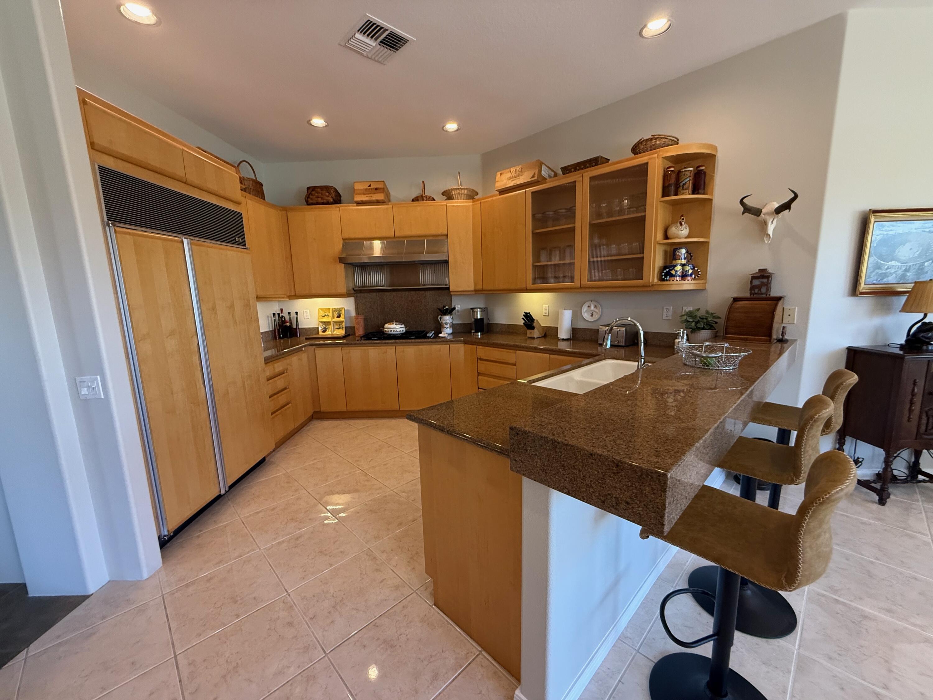 79765 Tangelo La Quinta, CA 92253 - Photo 30 of 55 a kitchen with sink refrigerator and cabinets