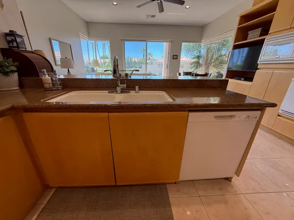a kitchen with stainless steel appliances granite countertop a sink and cabinets
