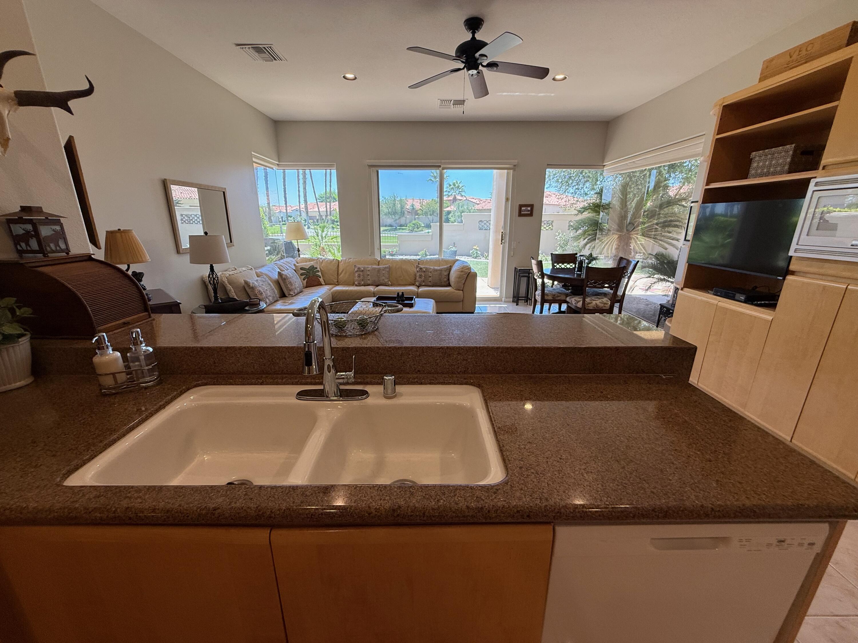 79765 Tangelo La Quinta, CA 92253 - Photo 32 of 55 a view of a dining room with furniture window and wooden floor