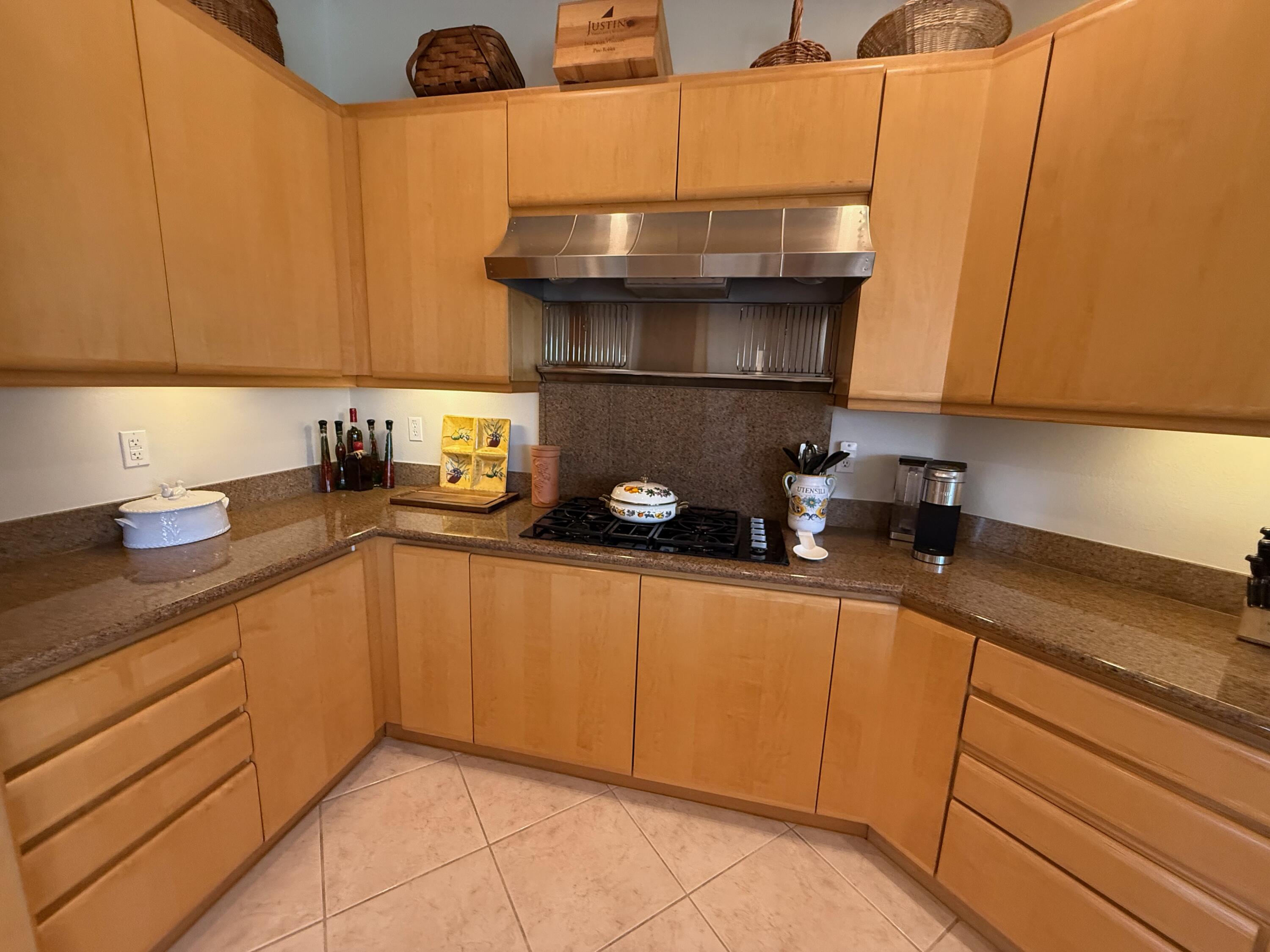 79765 Tangelo La Quinta, CA 92253 - Photo 33 of 55 a kitchen with granite countertop cabinets and a sink