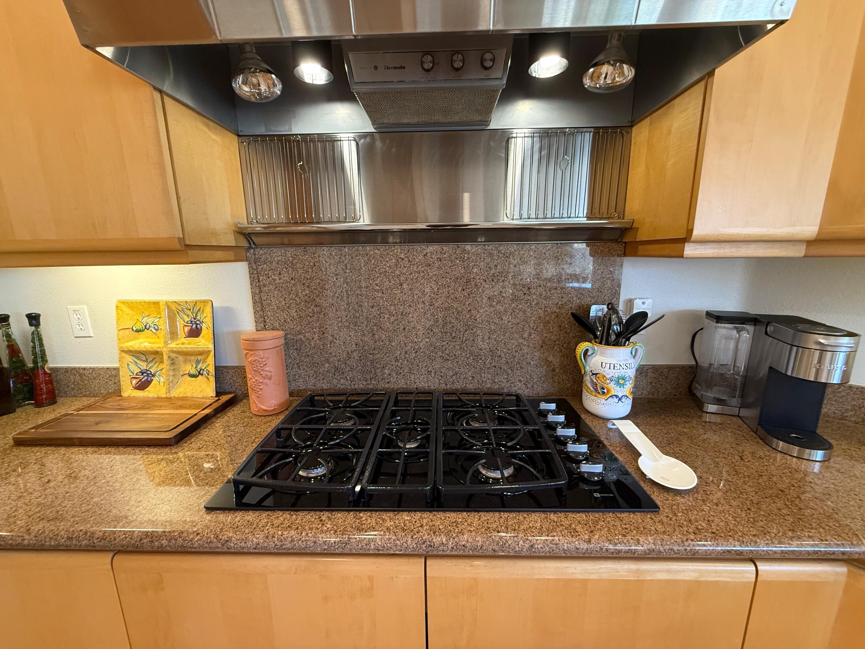 79765 Tangelo La Quinta, CA 92253 - Photo 34 of 55 a kitchen with kitchen island granite countertop a stove and a sink