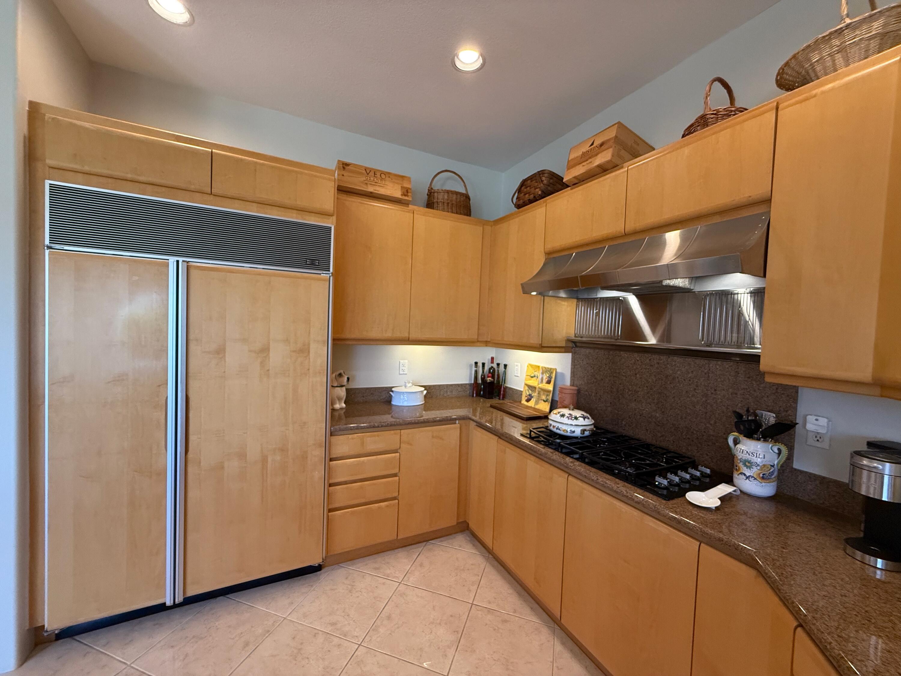79765 Tangelo La Quinta, CA 92253 - Photo 35 of 55 a kitchen with stainless steel appliances granite countertop a sink and cabinets