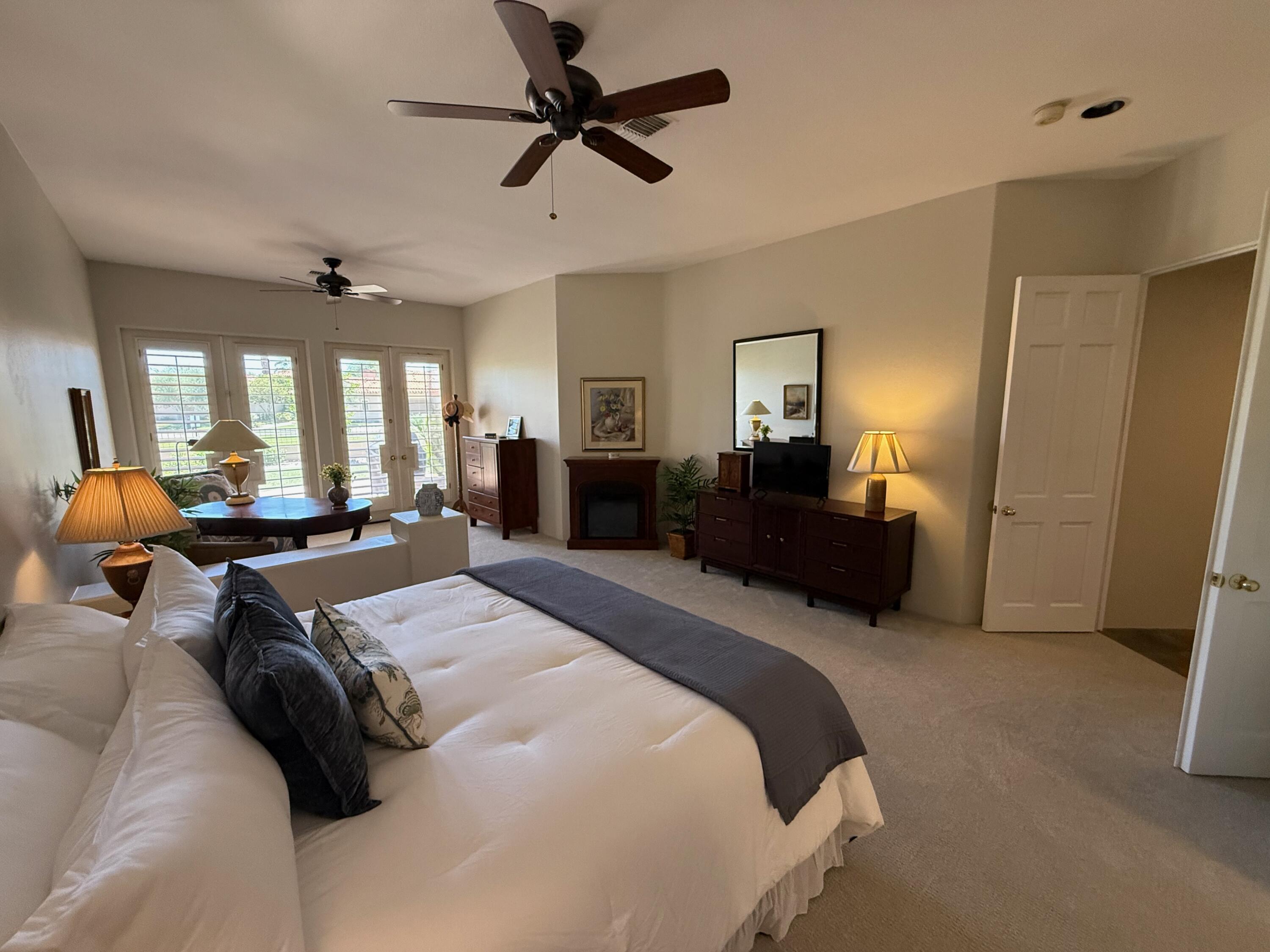 79765 Tangelo La Quinta, CA 92253 - Photo 39 of 55 a bed room with a bed mirror and a couch